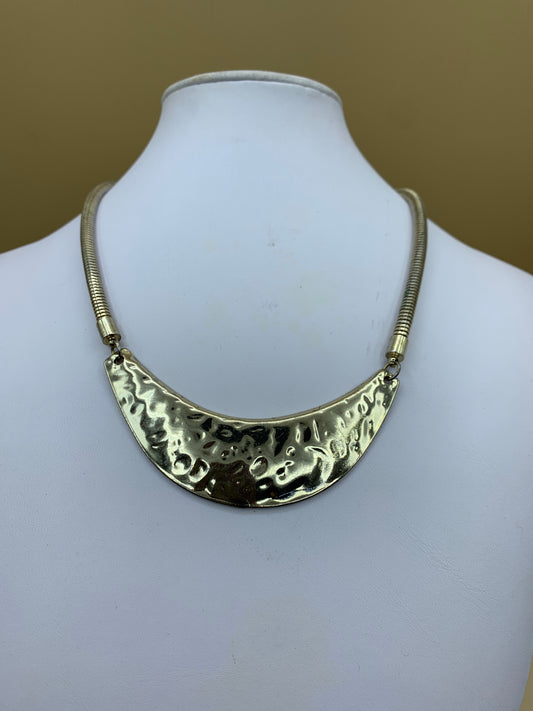 Necklace with crescent golden metal pendant